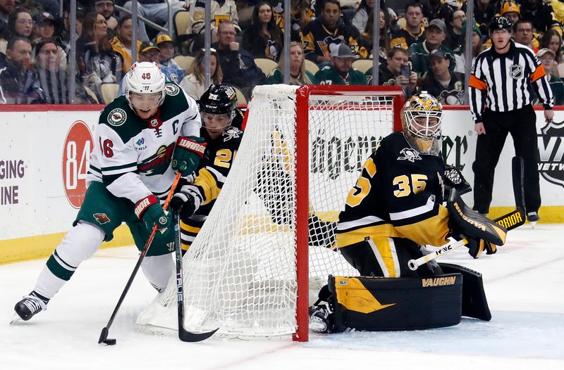 Apr 6, 2023; Pittsburgh, Pennsylvania, USA; Minnesota Wild defenseman Jared Spurgeon (46) skates to the net with the puck as Pittsburgh Penguins center Ryan Poehling (25) and goaltender Tristan Jarry (35) defend during the third period at PPG Paints Arena. Pittsburgh won 4-1. Mandatory Credit: Charles LeClaire-USA TODAY Sports