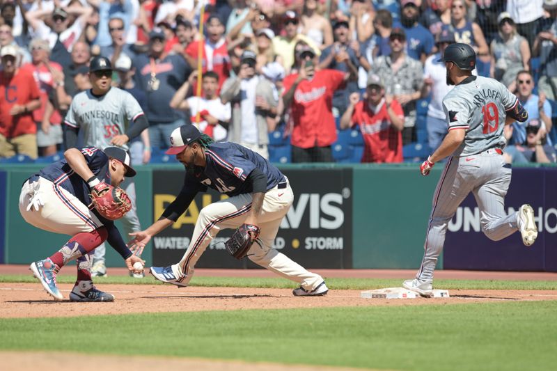 May 19, 2024; Cleveland, Ohio, USA; Cleveland Guardians first baseman Josh Naylor (22) and relief pitcher Emmanuel Clase (48) reach to grab the ball dropped by Clase during a play at first base as Minnesota Twins left fielder Alex Kirilloff (19) is safe during the ninth inning at Progressive Field. Mandatory Credit: Ken Blaze-USA TODAY Sports