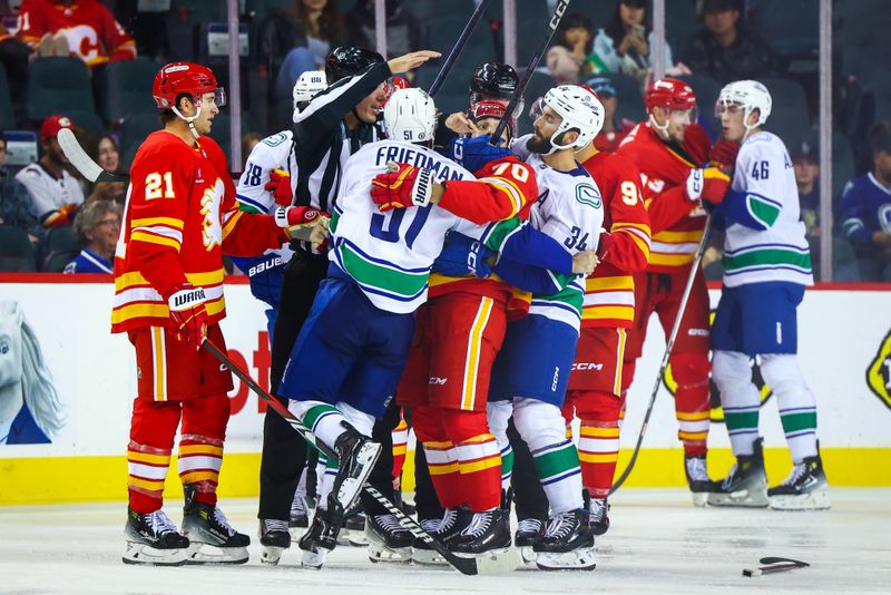 Sep 28, 2024; Calgary, Alberta, CAN; Calgary Flames and Vancouver Canucks gets into a scrum during the third period at Scotiabank Saddledome. Mandatory Credit: Sergei Belski-Imagn Images