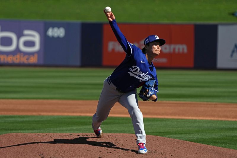 Feb 26, 2025; Phoenix, Arizona, USA; Los Angeles Dodgers pitcher Yoshinobu Yamamoto (18) throws against the Milwaukee Brewers during the first inning at American Family Fields of Phoenix. Mandatory Credit: Rick Scuteri-Imagn Images