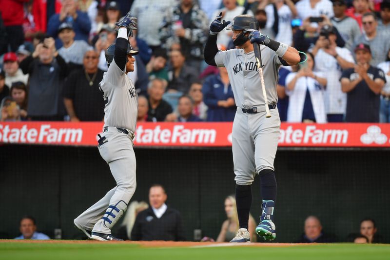 May 28, 2024; Anaheim, California, USA;  New York Yankees right fielder Juan Soto (22) is greeted by center fielder Aaron Judge (99) after hitting a solo home run against the Los Angeles Angels during the first inning at Angel Stadium. Mandatory Credit: Gary A. Vasquez-USA TODAY Sports