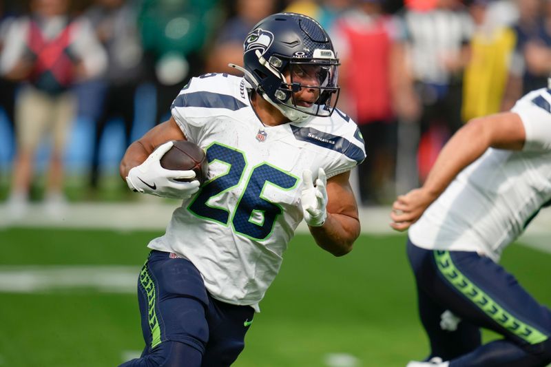 Seattle Seahawks running back Zach Charbonnet (26) runs against the Los Angeles Chargers during the first half of a preseason NFL football game in Inglewood, Calif., Saturday, Aug. 10, 2024. (AP Photo/Gregory Bull)