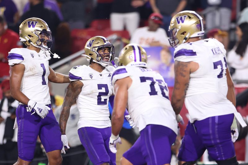 Nov 4, 2023; Los Angeles, California, USA; Washington Huskies wide receiver Ja'Lynn Polk (2) celebrates with his teammates after scoring a touchdown during the second quarter against the USC Trojans at United Airlines Field at Los Angeles Memorial Coliseum. Mandatory Credit: Jessica Alcheh-USA TODAY Sports