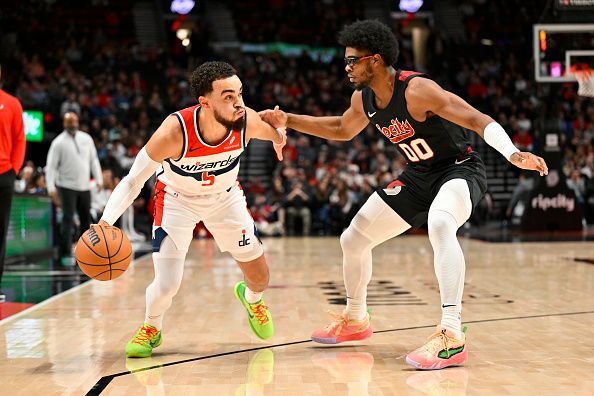 PORTLAND, OREGON - DECEMBER 21: Tyus Jones #5 of the Washington Wizards and Scoot Henderson #00 of the Portland Trail Blazers in action during the first quarter of the game at the Moda Center on December 21, 2023 in Portland, Oregon. The Washington Wizards won 118-117. NOTE TO USER: User expressly acknowledges and agrees that, by downloading and or using this photograph, User is consenting to the terms and conditions of the Getty Images License Agreement. (Photo by Alika Jenner/Getty Images)