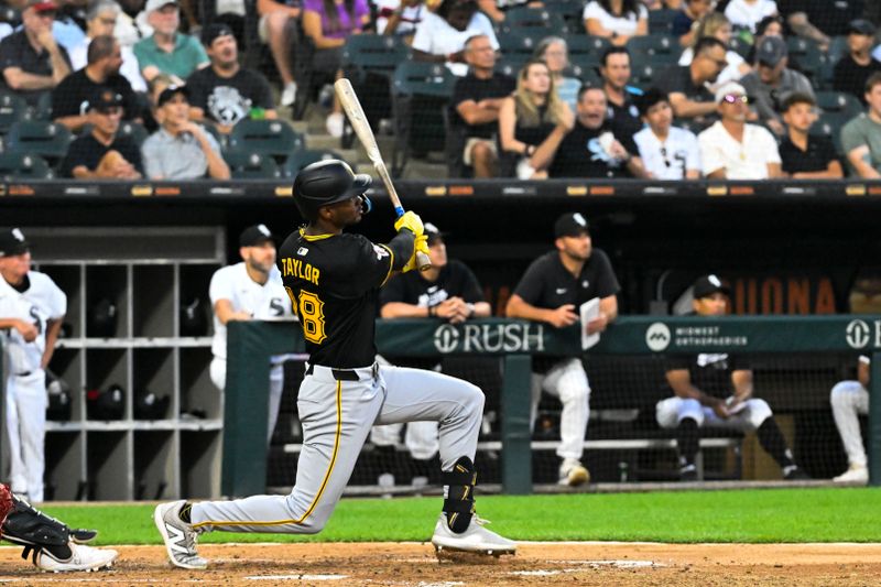 Jul 12, 2024; Chicago, Illinois, USA;  Pittsburgh Pirates outfielder Michael A. Taylor (18) hits an RBI sacrifice fly ball  against the Chicago White Sox during the fifth inning  at Guaranteed Rate Field. Mandatory Credit: Matt Marton-USA TODAY Sports