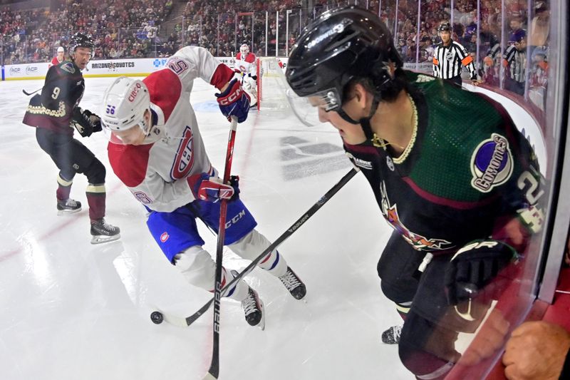 Nov 2, 2023; Tempe, Arizona, USA;  Arizona Coyotes center Barrett Hayton (29) and Montreal Canadiens right wing Jesse Ylonen (56) battle for the puck in the second period at Mullett Arena. Mandatory Credit: Matt Kartozian-USA TODAY Sports