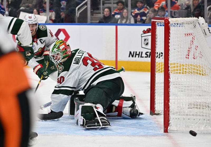 Dec 2, 2025; Edmonton, Alberta, CAN; Minnesota Wild defenseman Jared Spurgeon (46) and goalie Jesper Wallstedt (30) look for the puck during the third period at Rogers Place. Mandatory Credit: Walter Tychnowicz-Imagn Images