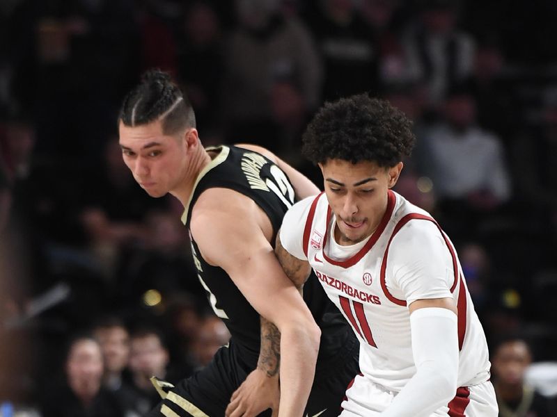 Jan 14, 2023; Nashville, Tennessee, USA; Arkansas Razorbacks forward Jalen Graham (11) steals the ball from Vanderbilt Commodores forward Quentin Millora-Brown (42) during the first half at Memorial Gymnasium. Mandatory Credit: Christopher Hanewinckel-USA TODAY Sports