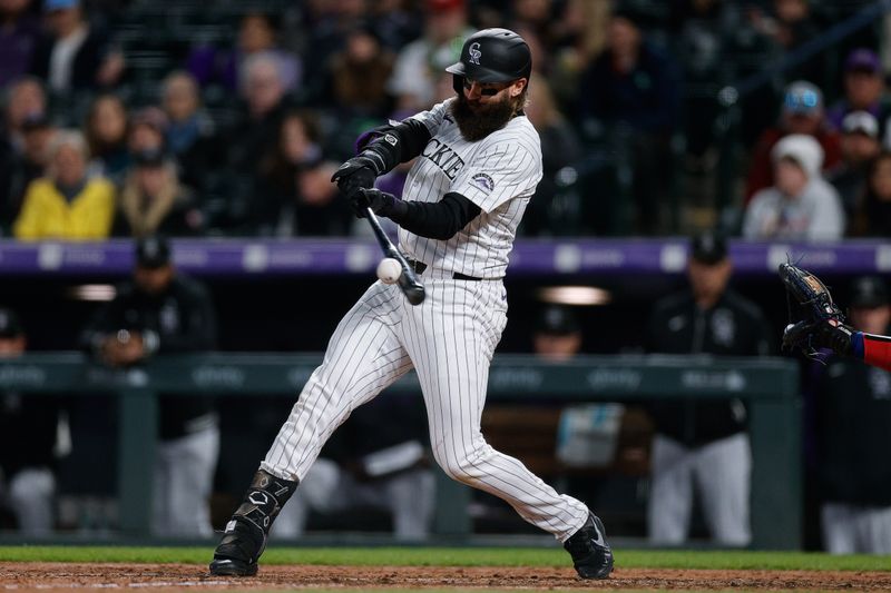 May 10, 2024; Denver, Colorado, USA; Colorado Rockies designated hitter Charlie Blackmon (19) hits a two RBI double in the eighth inning against the Texas Rangers at Coors Field. Mandatory Credit: Isaiah J. Downing-USA TODAY Sports