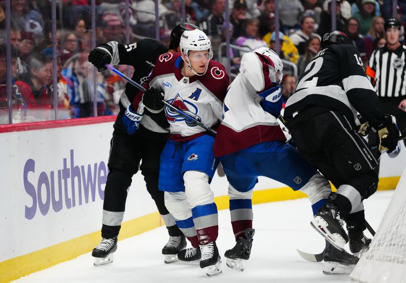 Dec 29, 2025; Denver, Colorado, USA; Los Angeles Kings defenseman Cody Ceci (5), left wing Trevor Moore (12), Colorado Avalanche center Nathan MacKinnon (29) and defenseman Devon Toews (7) behind the net in the first period at Ball Arena. Mandatory Credit: Ron Chenoy-Imagn Images