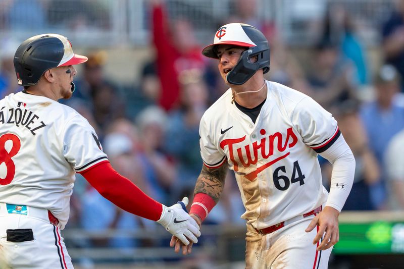 May 8, 2024; Minneapolis, Minnesota, USA; Minnesota Twins third baseman Jose Miranda (64) celebrates with catcher Christian Vazquez (8) later scoring a run against the Seattle Mariners in the fourth inning at Target Field. Mandatory Credit: Jesse Johnson-USA TODAY Sports