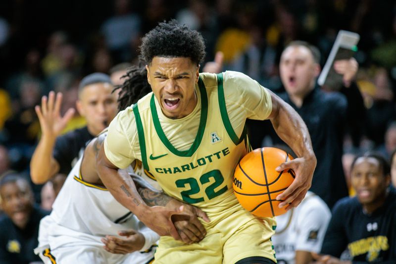 Jan 14, 2025; Wichita, Kansas, USA; Charlotte 49ers guard Jaehshon Thomas (22) drives to the basket during the first half against the Wichita State Shockers at Charles Koch Arena. Mandatory Credit: William Purnell-Imagn Images