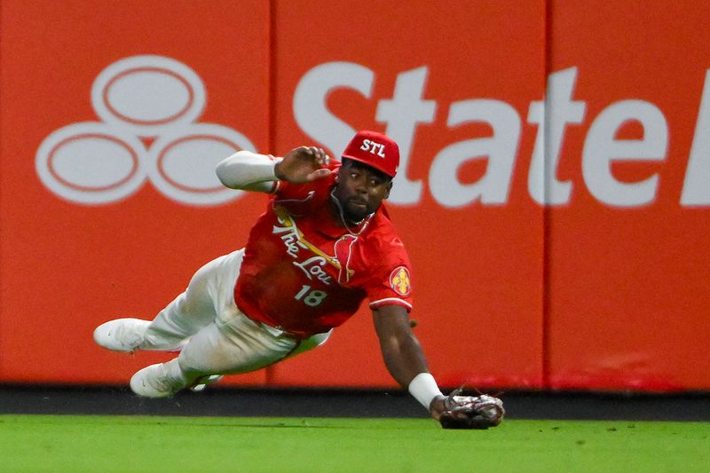 Apr 25, 2025; St. Louis, Missouri, USA;  St. Louis Cardinals right fielder Jordan Walker (18) dives but is unable to catch a single by Milwaukee Brewers left fielder Jackson Chourio (not pictured) during the eighth inning at Busch Stadium. Mandatory Credit: Jeff Curry-Imagn Images