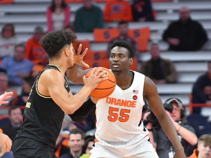 Dec 6, 2022; Syracuse, New York, USA; Syracuse Orange center Mounir Hima (55) plays defense against Oakland Golden Grizzlies forward Trey Townsend (4) in the second half  at JMA Wireless Dome. Mandatory Credit: Mark Konezny-USA TODAY Sports