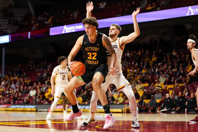 Nov 6, 2023; Minneapolis, Minnesota, USA; Bethune-Cookman Wildcats center Elijah Hulsewe (32) dribbles while Minnesota Golden Gophers forward Parker Fox (23) defends during the second half at Williams Arena. Mandatory Credit: Matt Krohn-USA TODAY Sports