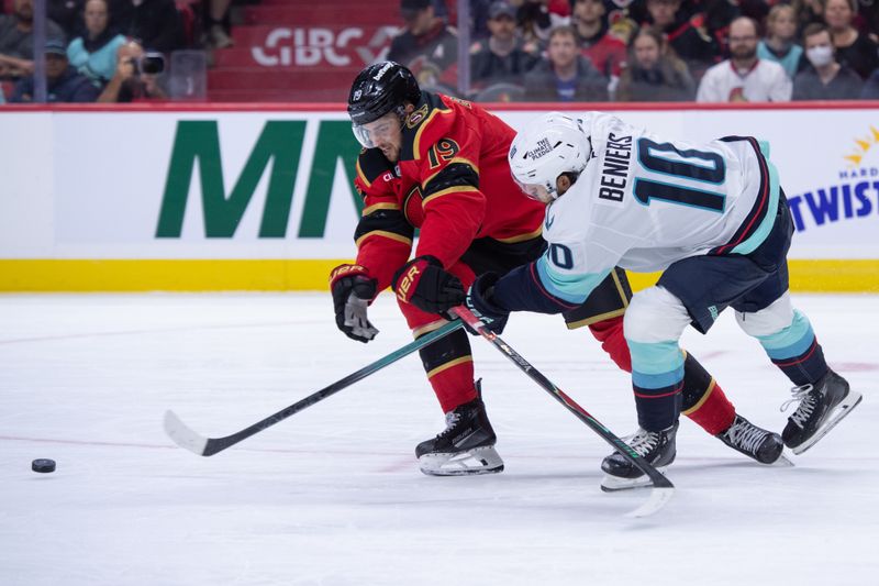 Oct 16, 2025; Ottawa, Ontario, CAN; Ottawa Senators right wing Drake Batherson (19) battles with Seattle Kraken center Matty Beniers (10) for control of the puck in the first period at the Canadian Tire Centre. Mandatory Credit: Marc DesRosiers-IMAGN Images