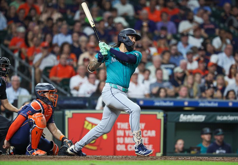 Sep 23, 2024; Houston, Texas, USA; Seattle Mariners shortstop J.P. Crawford (3) hits a single during the seventh inning against the Houston Astros at Minute Maid Park. Mandatory Credit: Troy Taormina-Imagn Images