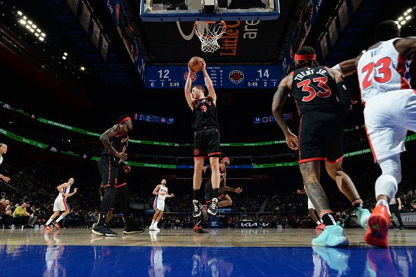 DETROIT, MI - DECEMBER 30:Jakob Poeltl #19 of the Toronto Raptors grabs a rebound during the game against the Detroit Pistons on December 30, 2023 at Little Caesars Arena in Detroit, Michigan. NOTE TO USER: User expressly acknowledges and agrees that, by downloading and/or using this photograph, User is consenting to the terms and conditions of the Getty Images License Agreement. Mandatory Copyright Notice: Copyright 2023 NBAE (Photo by Chris Schwegler/NBAE via Getty Images)