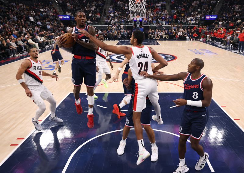 INGLEWOOD, CALIFORNIA - OCTOBER 30: Kevin Porter Jr. #77 of the LA Clippers controls a rebound in front of Kris Murray #24 of the Portland Trail Blazers during a 106-105 loss to the Trail Blazers at Intuit Dome on October 30, 2024 in Inglewood, California. (Photo by Harry How/Getty Images). NOTE TO USER: User expressly acknowledges and agrees that, by downloading and or using this photograph, User is consenting to the terms and conditions of the Getty Images License Agreement. (Photo by Harry How/Getty Images)