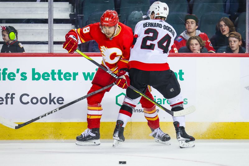 Jan 9, 2024; Calgary, Alberta, CAN; Calgary Flames left wing A.J. Greer (18) and Ottawa Senators defenseman Jacob Bernard-Docker (24) battle for the puck during the third period at Scotiabank Saddledome. Mandatory Credit: Sergei Belski-USA TODAY Sports