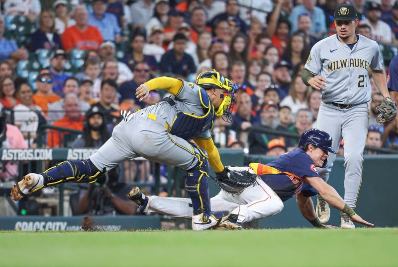 May 19, 2024; Houston, Texas, USA; Houston Astros center fielder Jake Meyers (6) is tagged out by Milwaukee Brewers catcher William Contreras (24) in a rundown during the seventh inning at Minute Maid Park. Mandatory Credit: Troy Taormina-USA TODAY Sports