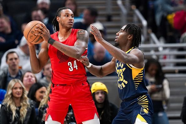 INDIANAPOLIS, INDIANA - NOVEMBER 27: Jabari Walker #34 of the Portland Trail Blazers handles the ball while being guarded by Aaron Nesmith #23 of the Indiana Pacers in the third quarter at Gainbridge Fieldhouse on November 27, 2023 in Indianapolis, Indiana. NOTE TO USER: User expressly acknowledges and agrees that, by downloading and or using this photograph, User is consenting to the terms and conditions of the Getty Images License Agreement. (Photo by Dylan Buell/Getty Images)