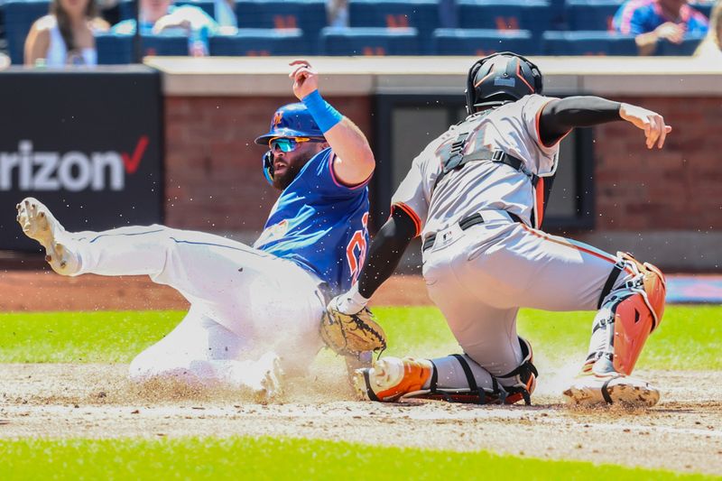 May 26, 2024; New York City, New York, USA;  New York Mets right fielder DJ Stewart (29) slides safely past the tag of San Francisco Giants catcher Patrick Bailey (14) in the second inning at Citi Field. Mandatory Credit: Wendell Cruz-USA TODAY Sports