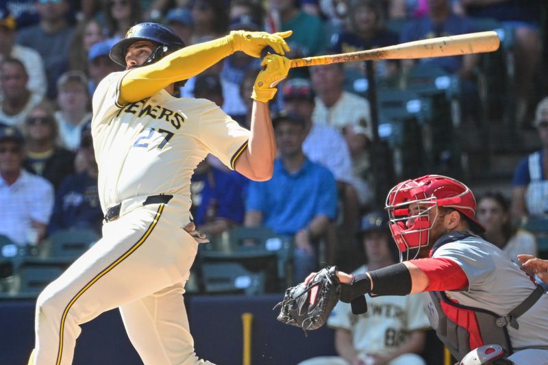 Sep 2, 2024; Milwaukee, Wisconsin, USA; Milwaukee Brewers shortstop Willy Adames (27) hits a 3-run home run in the first inning as St. Louis Cardinals catcher Pedro Pages (43) looks on at American Family Field. Mandatory Credit: Benny Sieu-USA TODAY Sports