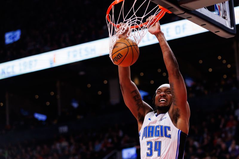 TORONTO, CANADA - JANUARY 3: Wendell Carter Jr. #34 of the Orlando Magic dunks the ball against the Toronto Raptors during first half of their NBA game at Scotiabank Arena on January 3, 2025 in Toronto, Canada. NOTE TO USER: User expressly acknowledges and agrees that, by downloading and or using this photograph, User is consenting to the terms and conditions of the Getty Images License Agreement. (Photo by Cole Burston/Getty Images)