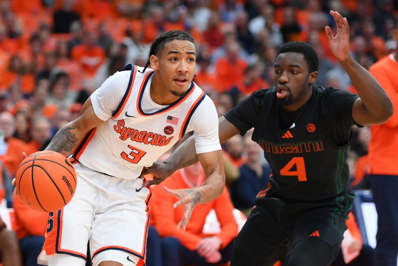 Jan 20, 2024; Syracuse, New York, USA; Syracuse Orange guard Judah Mintz (3) drives to the basket against the defense of Miami (Fl) Hurricanes guard Bensley Joseph (4) during the second half at the JMA Wireless Dome. Mandatory Credit: Rich Barnes-USA TODAY Sports