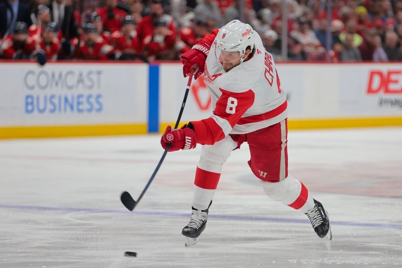 Apr 10, 2025; Sunrise, Florida, USA; Detroit Red Wings defenseman Ben Chiarot (8) shoots the puck against the Florida Panthers during the second period at Amerant Bank Arena. Mandatory Credit: Sam Navarro-Imagn Images