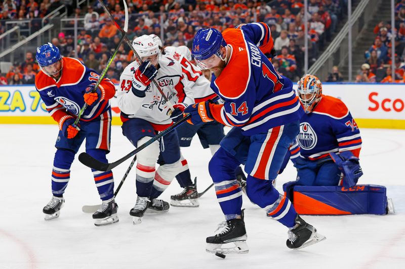 Jan 21, 2025; Edmonton, Alberta, CAN; Edmonton Oilers defensemen Mattias Ekholm (14) clears a loose puck from in front of Edmonton Oilers goaltender Stuart Skinner (74) during the second period at Rogers Place. Mandatory Credit: Perry Nelson-Imagn Images