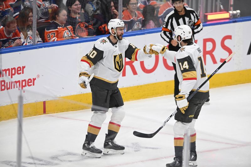 May 10, 2025; Edmonton, Alberta, CAN; Las Vegas Golden Knights  centre Nicolas Roy (10) and defenceman Nicolas Hague (14) celebrate a goal on Edmonton Oilers goalie Stuart Skinner (74) during the first period in game three of the second round of the 2025 Stanley Cup Playoffs at Rogers Place. Mandatory Credit: Walter Tychnowicz-Imagn Images