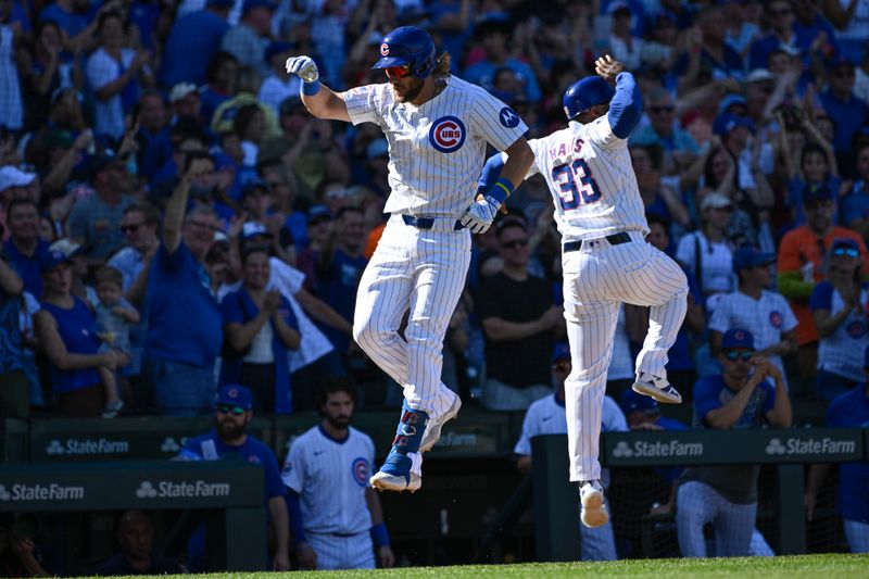 Sep 21, 2024; Chicago, Illinois, USA;  Chicago Cubs first baseman Patrick Wisdom (16) celebrates with third base coach Willie Harris (33) after he hit a home run against the Washington Nationals during the seventh inning at Wrigley Field. Mandatory Credit: Matt Marton-Imagn Images