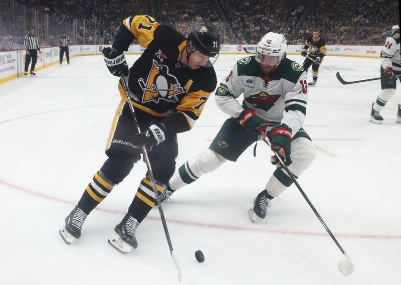 Nov 21, 2025; Pittsburgh, Pennsylvania, USA;  Pittsburgh Penguins center Evgeni Malkin (71) moves the puck against Minnesota Wild center Yakov Trenin (13) during the first period at PPG Paints Arena. Mandatory Credit: Charles LeClaire-Imagn Images