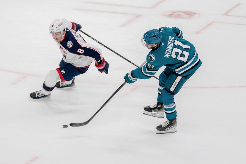 Nov 5, 2024; San Jose, California, USA;  San Jose Sharks center Alexander Wennberg (21) shoots and scores in overtime against Columbus Blue Jackets defenseman Zach Werenski (8) to win the game at SAP Center at San Jose. Mandatory Credit: Neville E. Guard-Imagn Images