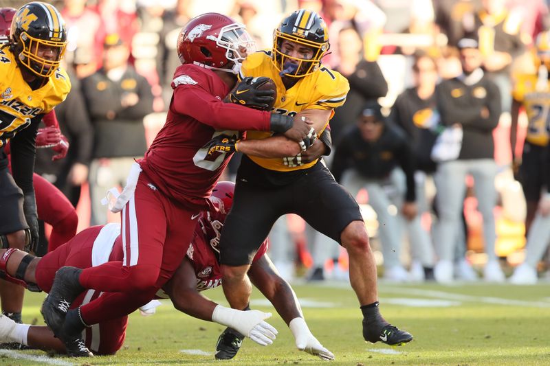 Nov 24, 2023; Fayetteville, Arkansas, USA; Missouri Tigers running back Cody Schrader (7) rushes against the Arkansas Razorbacks during the second quarter at Donald W. Reynolds Razorback Stadium. Mandatory Credit: Nelson Chenault-USA TODAY Sports