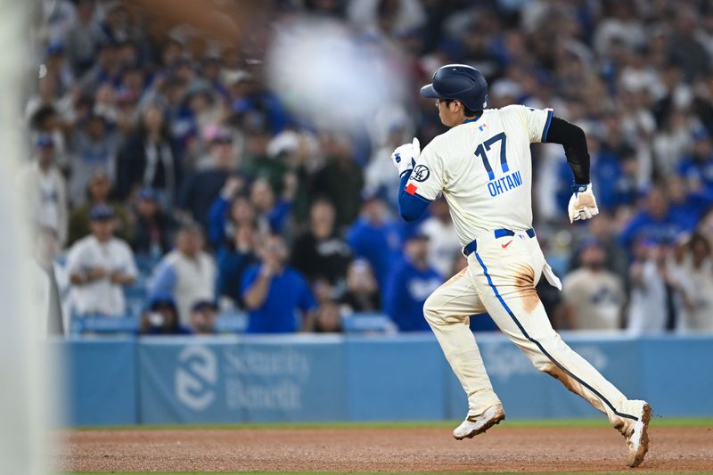 Sep 21, 2024; Los Angeles, California, USA; Los Angeles Dodgers designated hitter Shohei Ohtani (17) steals third base against the Colorado Rockies during the ninth inning at Dodger Stadium. Mandatory Credit: Jonathan Hui-Imagn Images