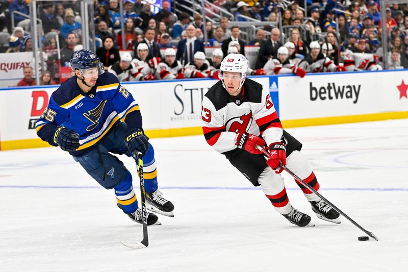 Nov 3, 2023; St. Louis, Missouri, USA;  New Jersey Devils left wing Jesper Bratt (63) controls the puck as St. Louis Blues center Jordan Kyrou (25) defends during the third period at Enterprise Center. Mandatory Credit: Jeff Curry-USA TODAY Sports