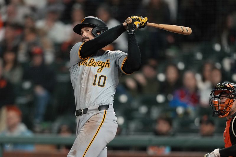 Apr 27, 2024; San Francisco, California, USA; Pittsburgh Pirates left fielder Bryan Reynolds (10) hits a home run against the San Francisco Giants during the tenth inning at Oracle Park. Mandatory Credit: Darren Yamashita-USA TODAY Sports