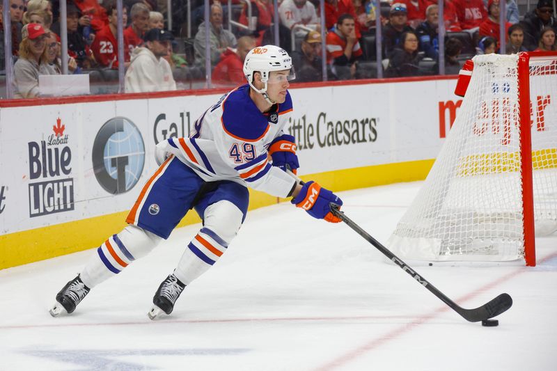 Oct 27, 2024; Detroit, Michigan, USA; Edmonton Oilers defenseman Ty Emberson (49) handles the puck during the second period of the game against the Detroit Red Wings at Little Caesars Arena. Mandatory Credit: Brian Bradshaw Sevald-Imagn Images