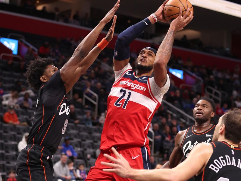 DETROIT, MICHIGAN - JANUARY 27: Daniel Gafford #21 of the Washington Wizards tries to get a shot off around Ausar Thompson #9 of the Detroit Pistons during the first half at Little Caesars Arena on January 27, 2024 in Detroit, Michigan. NOTE TO USER: User expressly acknowledges and agrees that, by downloading and or using this photograph, User is consenting to the terms and conditions of the Getty Images License  (Photo by Gregory Shamus/Getty Images)