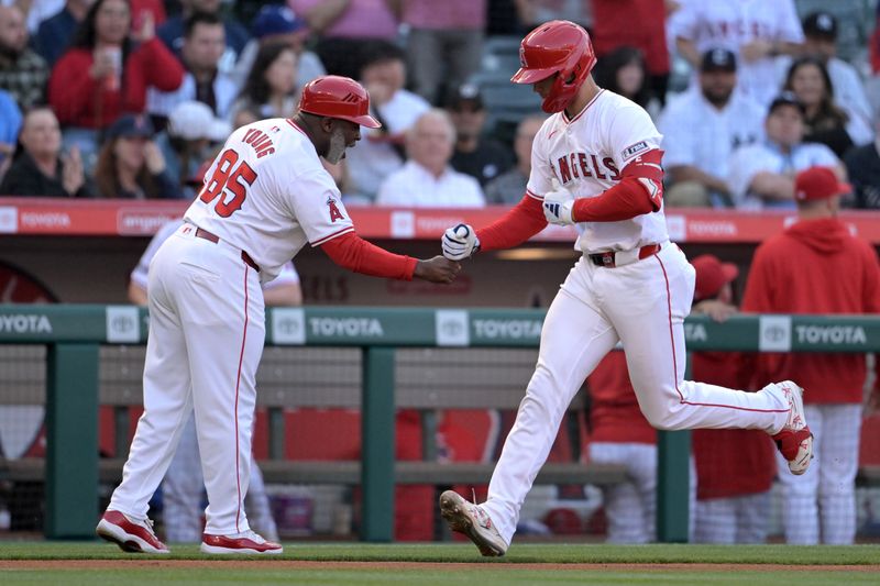 May 30, 2024; Anaheim, California, USA;  Los Angeles Angels catcher Logan O'Hoppe (14) is greeted by third base coach Eric Young Sr. (85) after hitting a solo home run in the first inning against the New York Yankees at Angel Stadium. Mandatory Credit: Jayne Kamin-Oncea-USA TODAY Sports