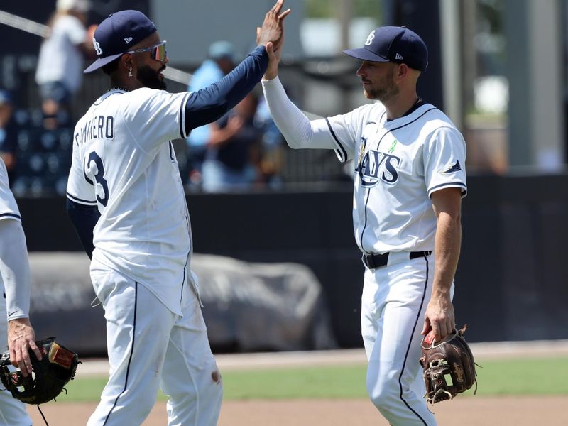 May 28, 2025; Tampa, FL, USA; Tampa Bay Rays third base Junior Caminero (13) and second base Brandon Lowe (8) celebrate after they beat the Minnesota Twins at George M. Steinbrenner Field. Mandatory Credit: Kim Klement Neitzel-Imagn Images