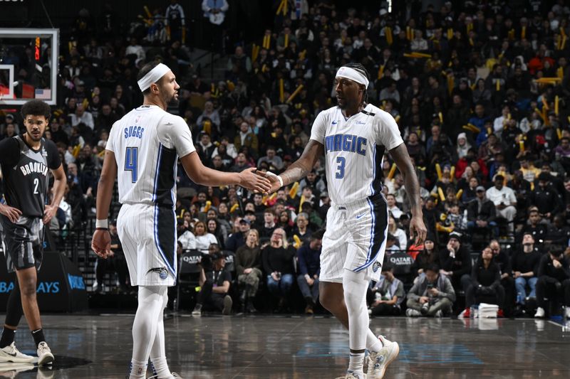 BROOKLYN, NY - DECEMBER 1: Kentavious Caldwell-Pope #3 and Jalen Suggs #4 of the Orlando Magic high five during the game against the Brooklyn Nets on December 1, 2024 at Barclays Center in Brooklyn, New York. NOTE TO USER: User expressly acknowledges and agrees that, by downloading and or using this Photograph, user is consenting to the terms and conditions of the Getty Images License Agreement. Mandatory Copyright Notice: Copyright 2024 NBAE (Photo by David Dow/NBAE via Getty Images)