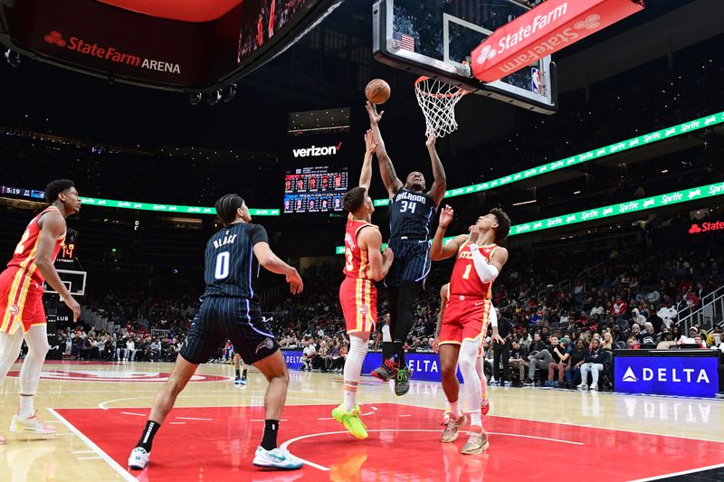 ATLANTA, GA - FEBRUARY 25: Wendell Carter Jr. #34 of the Orlando Magic shoots the ball during the game against the Atlanta Hawks on February 25, 2024 at State Farm Arena in Atlanta, Georgia.  NOTE TO USER: User expressly acknowledges and agrees that, by downloading and/or using this Photograph, user is consenting to the terms and conditions of the Getty Images License Agreement. Mandatory Copyright Notice: Copyright 2024 NBAE (Photo by Scott Cunningham/NBAE via Getty Images)