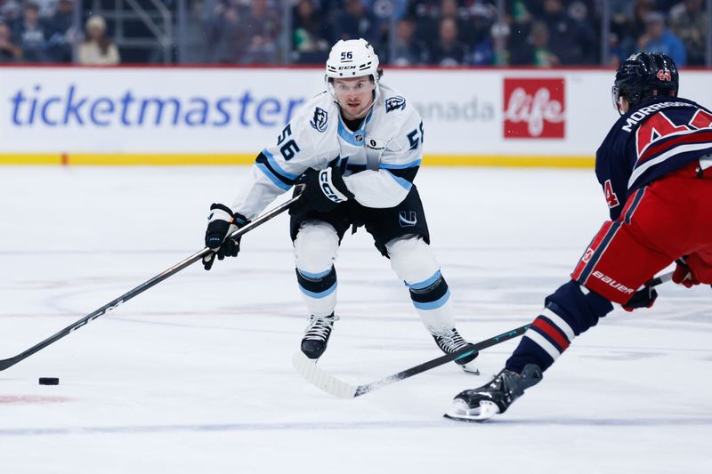 Oct 26, 2025; Winnipeg, Manitoba, CAN; Utah Mammoth forward forward Kailer Yamamoto (56) skates in on Winnipeg Jets defenseman Josh Morrissey (44) during the first period at Canada Life Centre. Mandatory Credit: Terrence Lee-Imagn Images