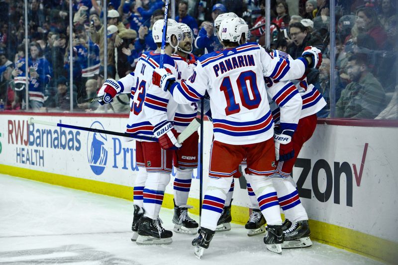 Feb 22, 2024; Newark, New Jersey, USA; New York Rangers center Mika Zibanejad (93) celebrates with teammates after scoring a goal against the New Jersey Devils during the first period at Prudential Center. Mandatory Credit: John Jones-USA TODAY Sports