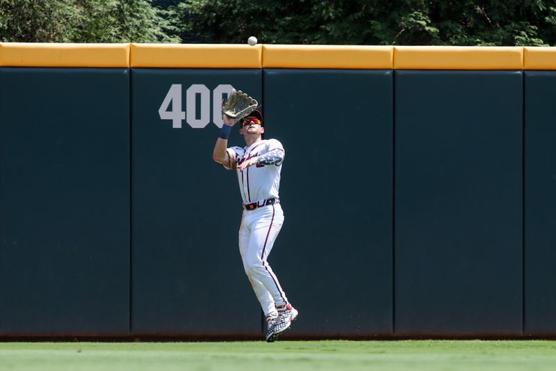 Jul 7, 2024; Atlanta, Georgia, USA; Atlanta Braves first baseman Matt Olson (28) catches a fly ball against the Philadelphia Phillies in the sixth inning at Truist Park. Mandatory Credit: Brett Davis-USA TODAY Sports