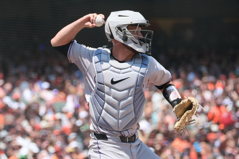 Jul 28, 2024; San Francisco, California, USA; Colorado Rockies catcher Jacob Stallings (25) makes a throwing error to second base against the San Francisco Giants during the third inning at Oracle Park. Mandatory Credit: Robert Edwards-USA TODAY Sports